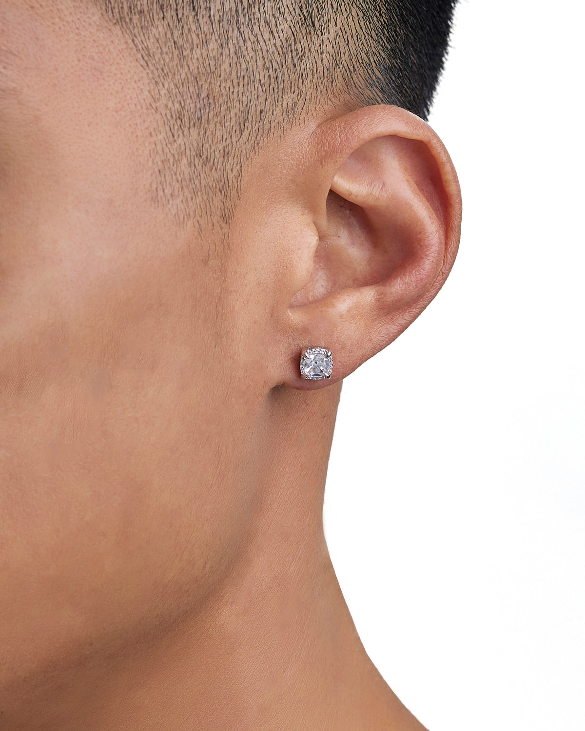 Model wearing white gold diamond earrings by Iceman Society