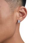 Model wearing white gold diamond earrings by Iceman Society