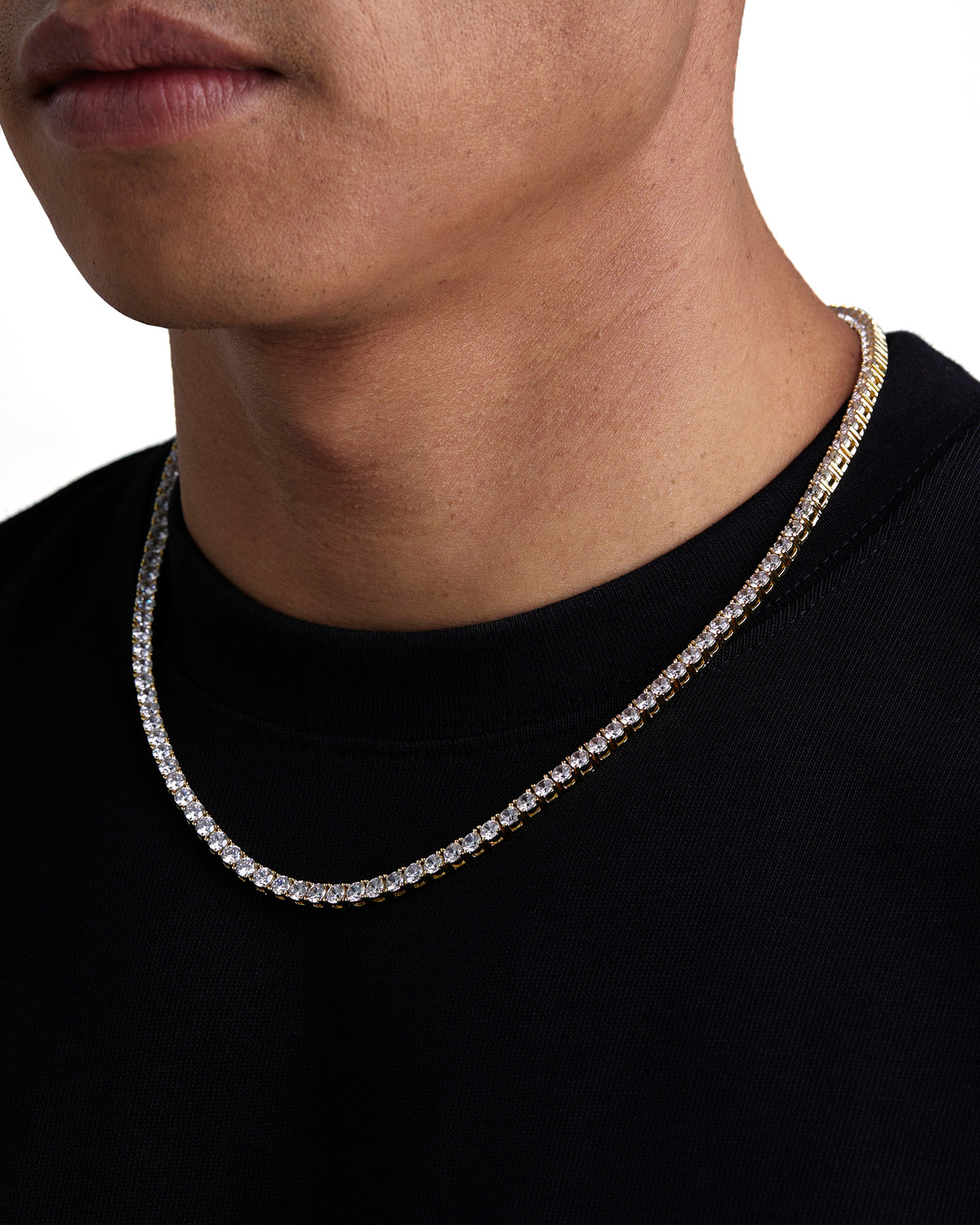 Model wearing 4mm 18k gold tennis necklace by Iceman Society, side view