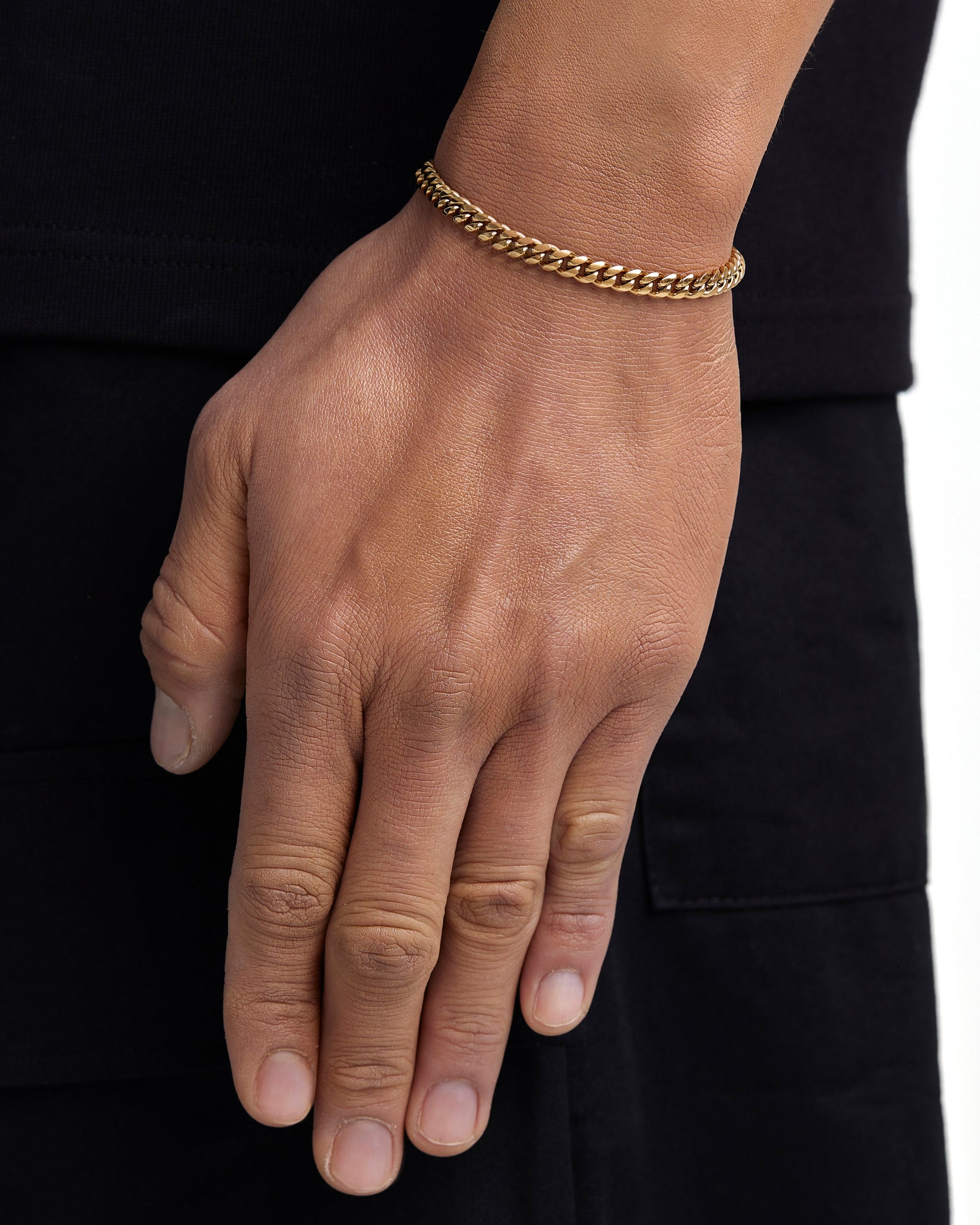 Model wearing 5mm 18K gold plain cuban chain set by Iceman Society, side view